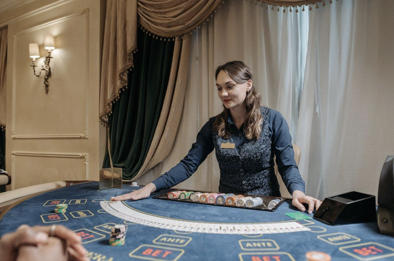 Blackjack dealer at table with chips